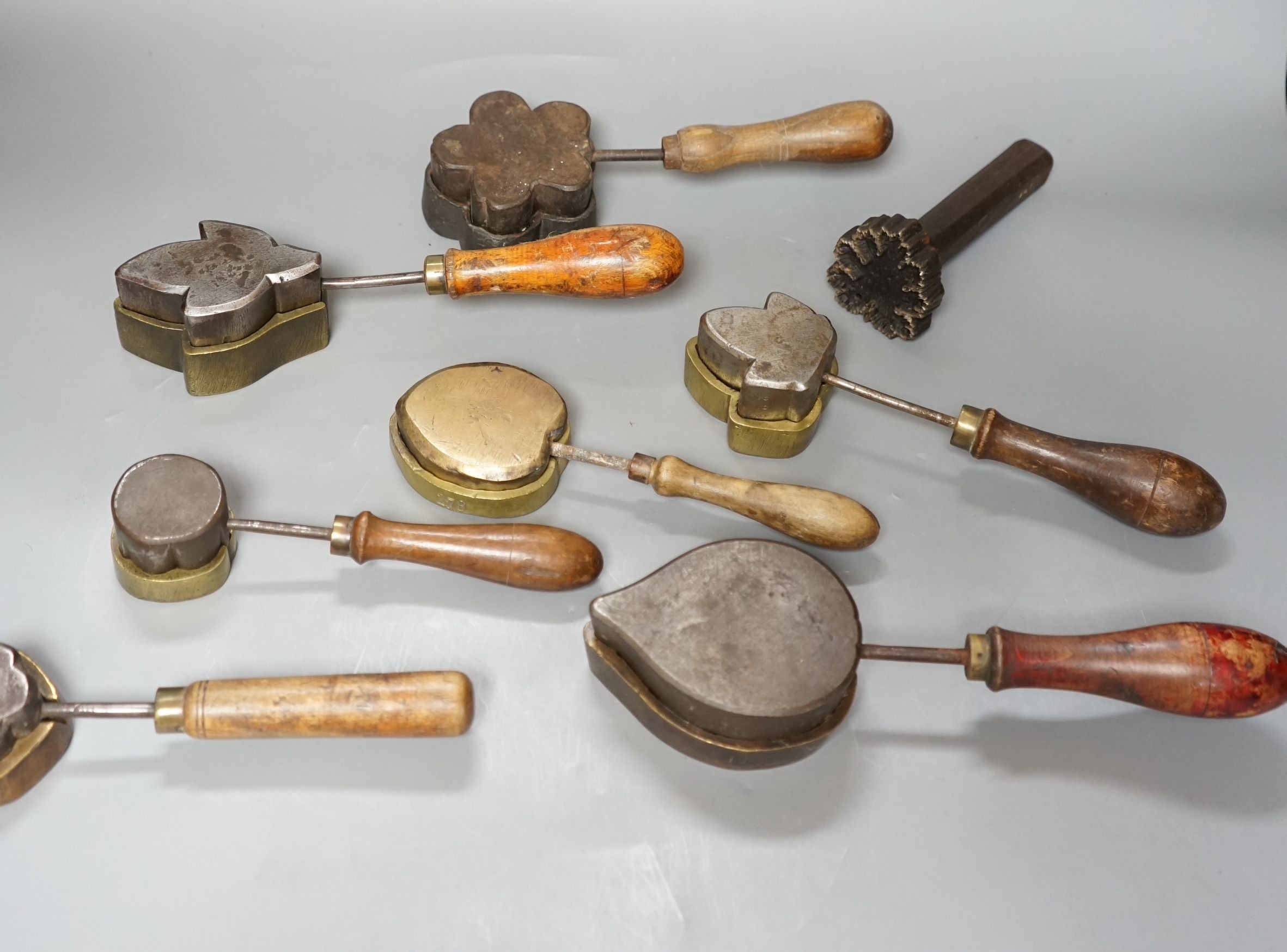 A collection of eight 19th century cast metal floral moulds, possibly for embossing silk